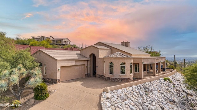 view of front of home with covered porch and a garage