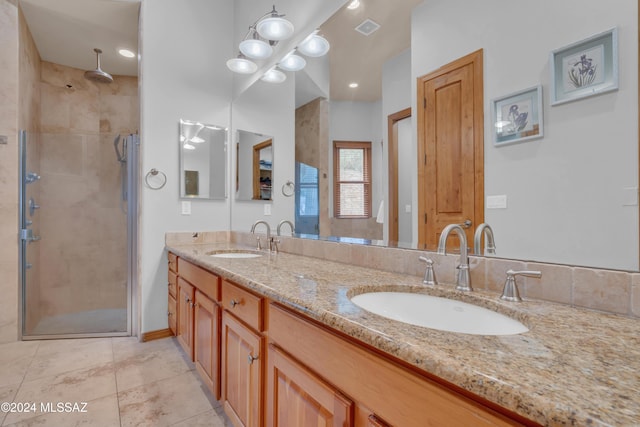 bathroom featuring tile patterned flooring, vanity, and an enclosed shower