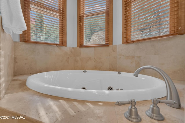 bathroom with a tub to relax in