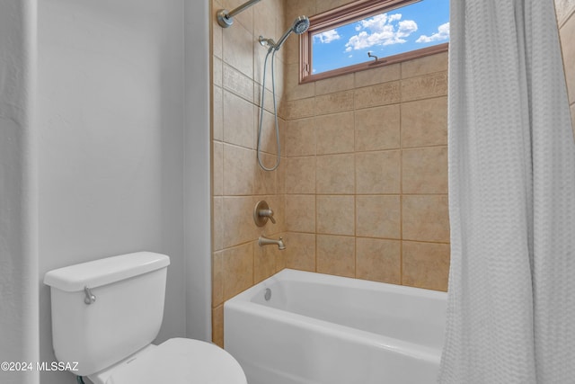 bathroom with toilet and shower / bath combo with shower curtain