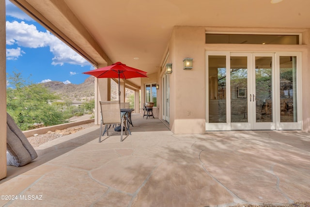 view of patio featuring a mountain view and french doors