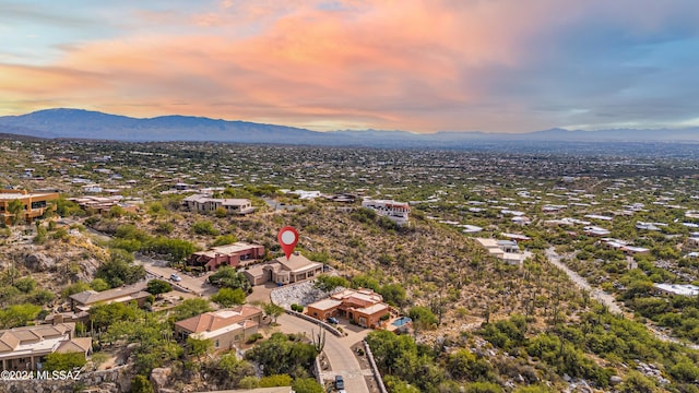 aerial view at dusk featuring a mountain view