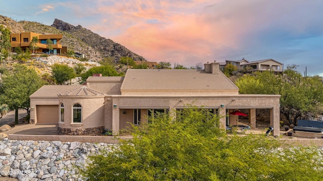 exterior space with a mountain view and a garage