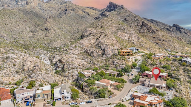 aerial view at dusk featuring a mountain view