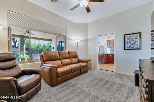 living room featuring light carpet and ceiling fan