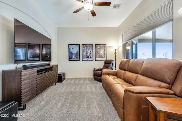 carpeted home theater room featuring ceiling fan