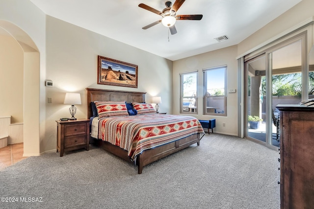 bedroom with access to outside, ceiling fan, and light colored carpet