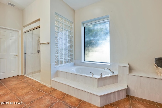 bathroom with shower with separate bathtub, tile patterned floors, and a wealth of natural light