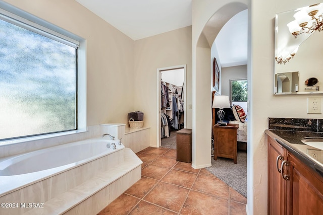 bathroom with tile patterned flooring, vanity, and a bathtub