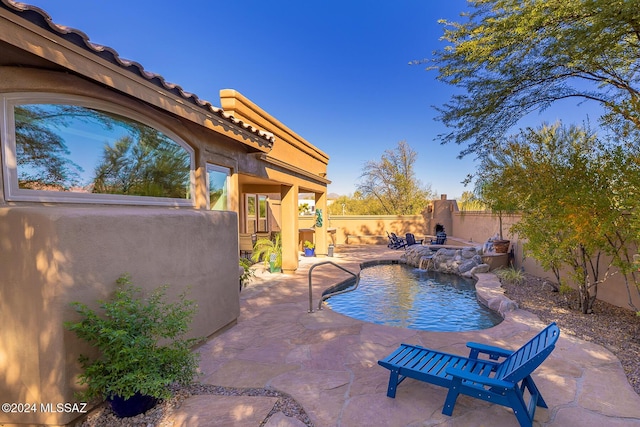 view of pool with pool water feature and a patio area