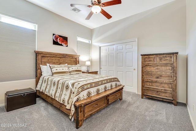 bedroom featuring ceiling fan, a closet, and carpet floors