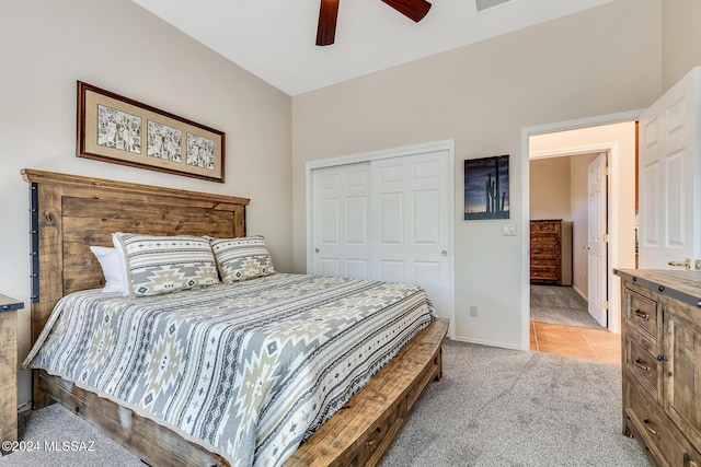 bedroom featuring a closet, light colored carpet, and ceiling fan