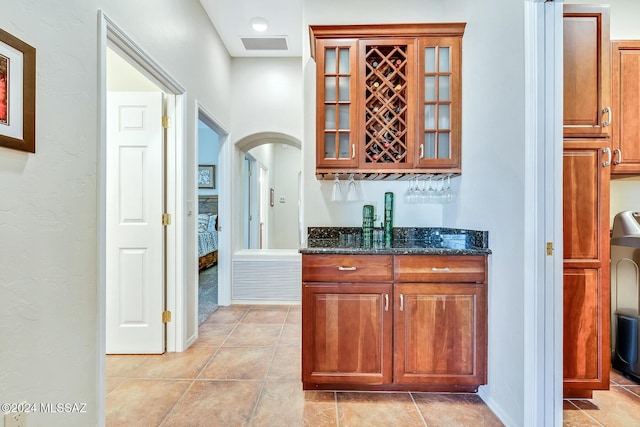 bar featuring dark stone countertops