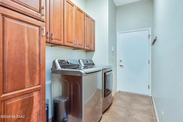 washroom with cabinets and washing machine and dryer