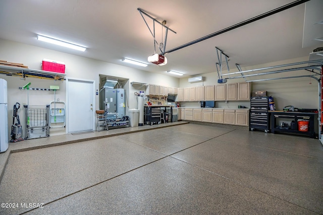 garage featuring white refrigerator and a garage door opener