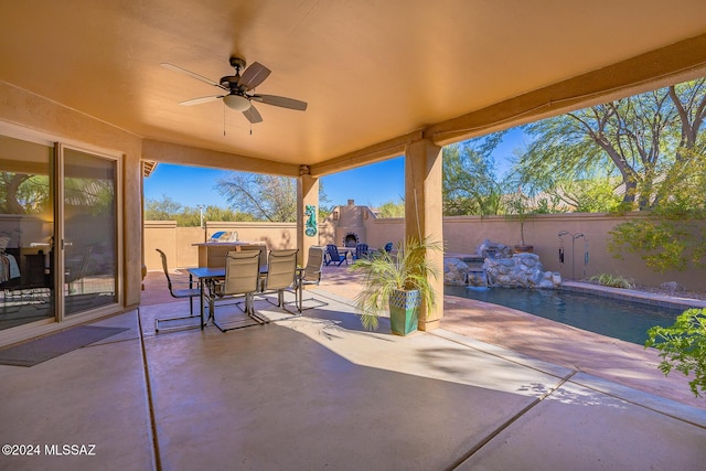 view of patio / terrace with ceiling fan and exterior fireplace