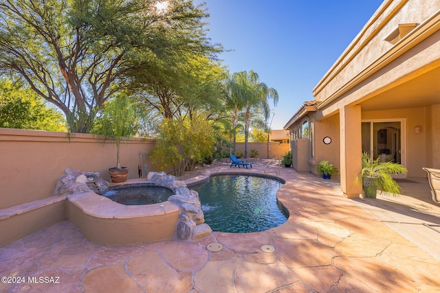 view of pool featuring an in ground hot tub and a patio