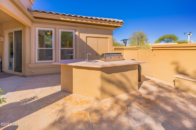 view of patio featuring sink and exterior kitchen