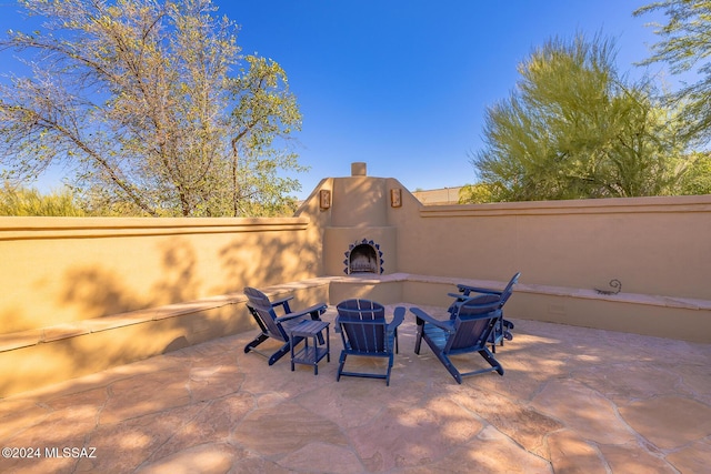 view of patio / terrace featuring exterior fireplace