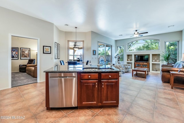 kitchen with dishwasher, sink, decorative light fixtures, a kitchen island with sink, and light tile patterned flooring