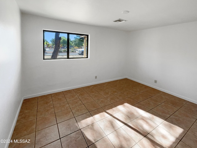 unfurnished room with light tile patterned flooring