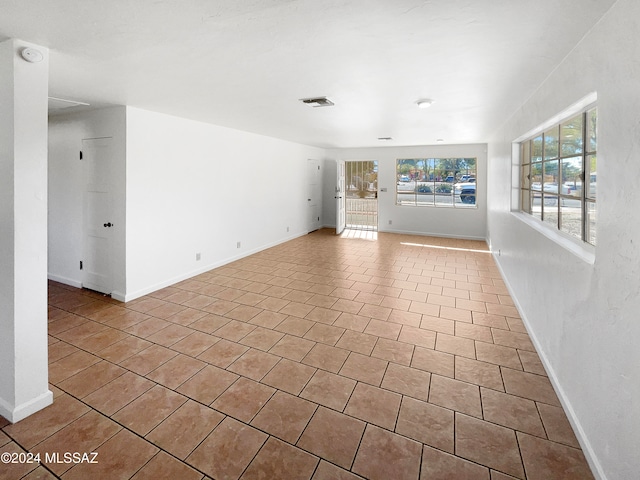 unfurnished living room with light tile patterned floors