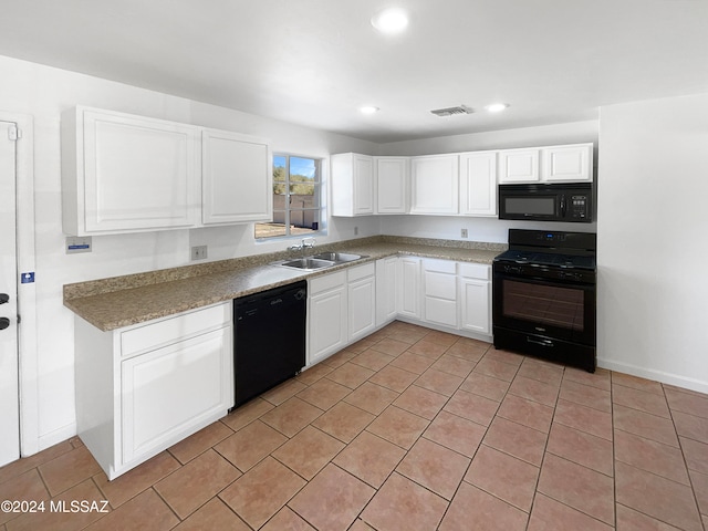 kitchen featuring sink, white cabinets, black appliances, and light tile patterned floors