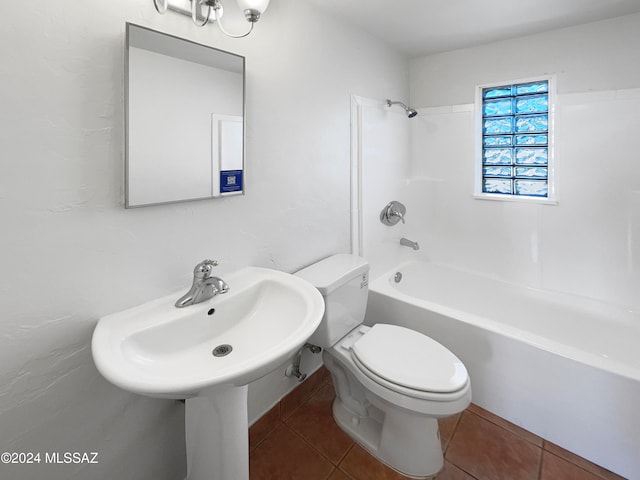 bathroom with tile patterned flooring, bathing tub / shower combination, and toilet