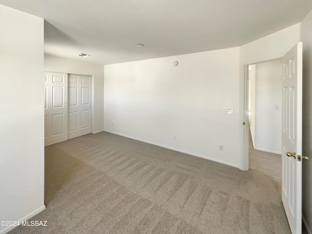 empty room featuring light carpet