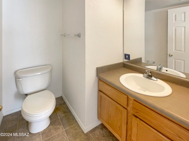 bathroom featuring tile patterned flooring, vanity, and toilet