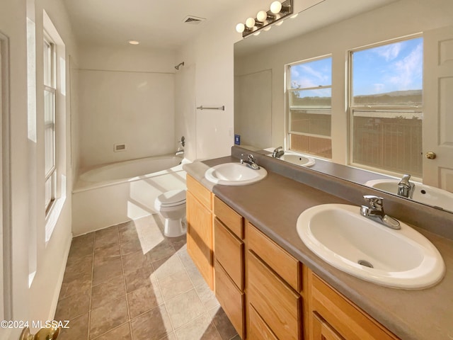 bathroom featuring tile patterned flooring, vanity, and toilet