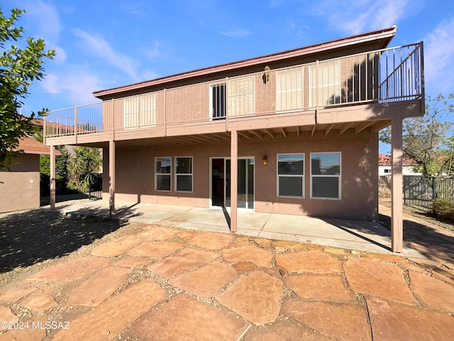 back of property with a patio and a balcony