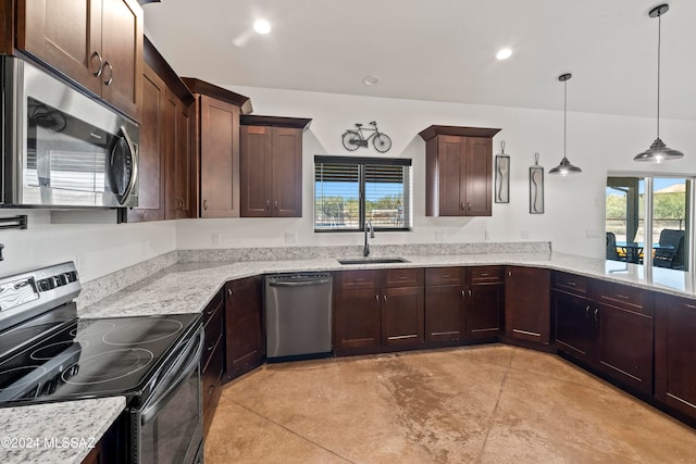 kitchen featuring pendant lighting, sink, appliances with stainless steel finishes, light stone counters, and kitchen peninsula