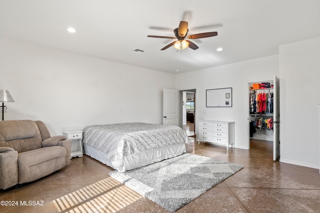 bedroom with ceiling fan, a spacious closet, and a closet