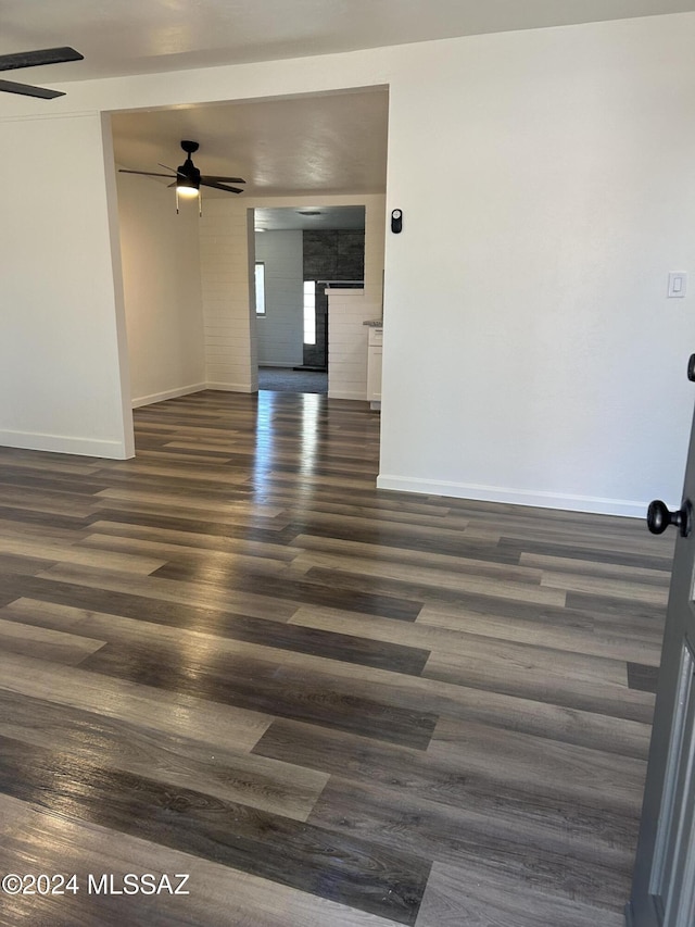 unfurnished room featuring dark hardwood / wood-style floors and ceiling fan