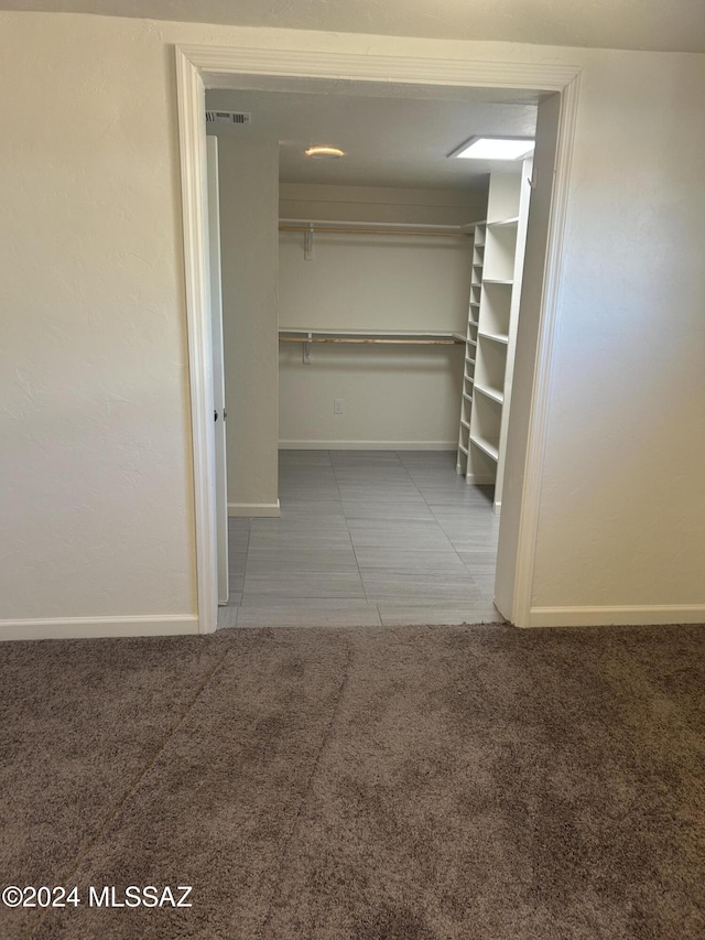 walk in closet with carpet