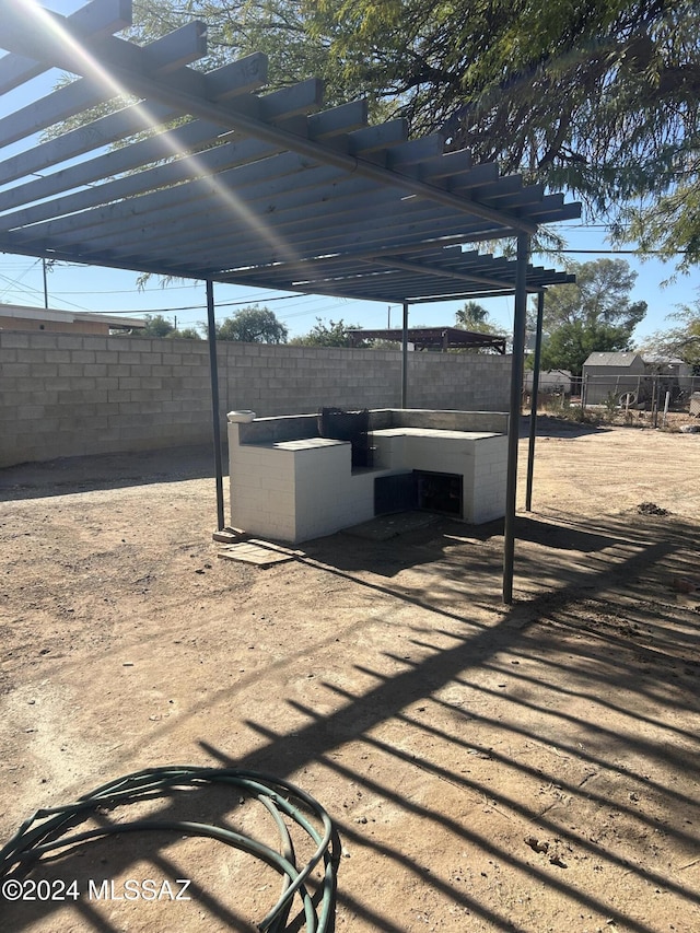 view of patio / terrace with a pergola and exterior kitchen