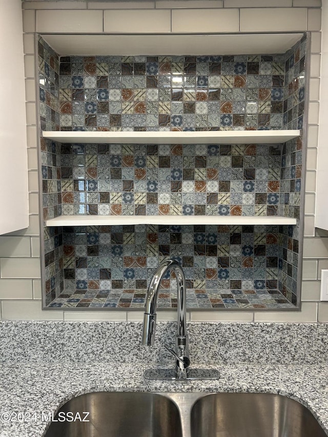 room details featuring sink and tasteful backsplash