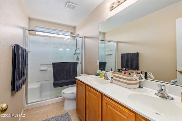 full bath with a stall shower, toilet, tile patterned flooring, and double vanity