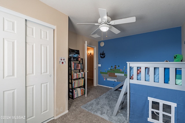 carpeted bedroom with a textured ceiling, a closet, and ceiling fan