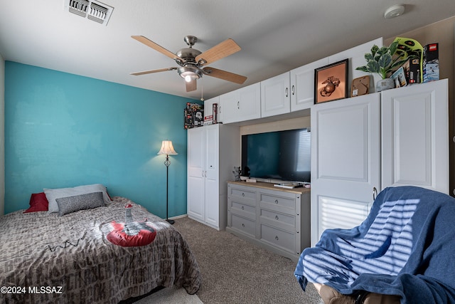 carpeted bedroom featuring ceiling fan and a closet