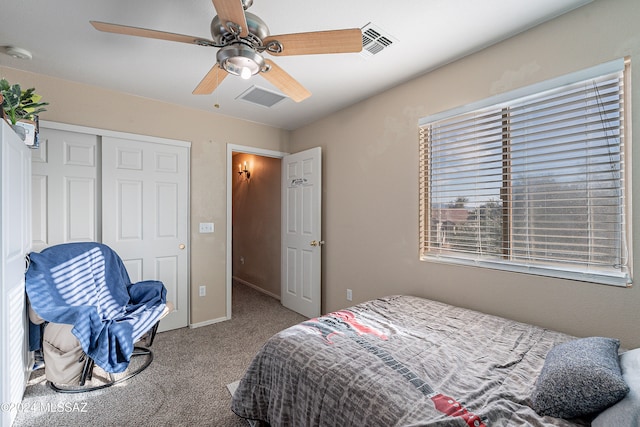 carpeted bedroom with ceiling fan and a closet