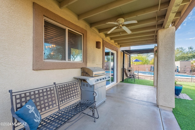 view of patio with fence, a ceiling fan, and area for grilling