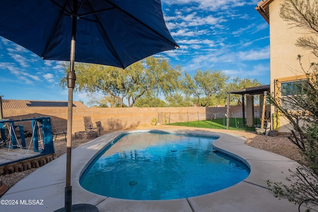 view of pool featuring a fenced backyard and a patio area