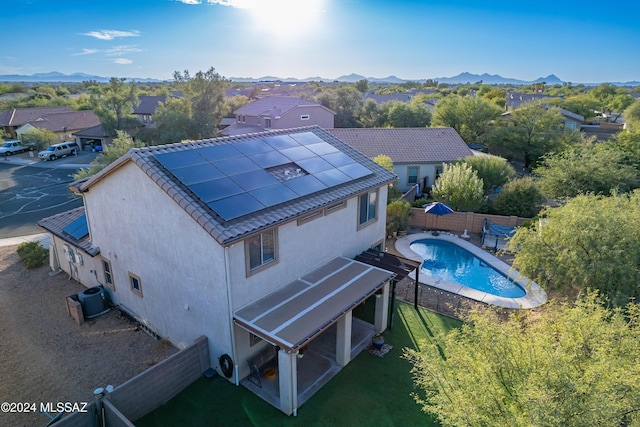 drone / aerial view of a mountainous background and a pool area