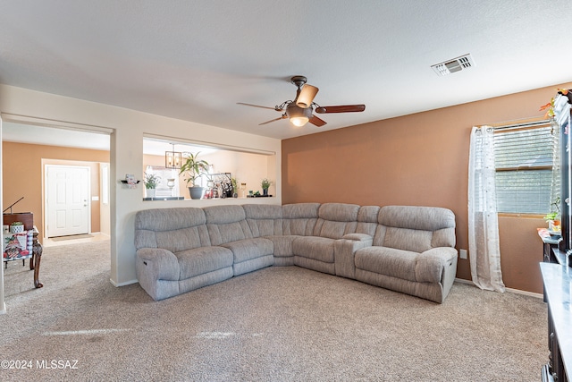 carpeted living room with ceiling fan