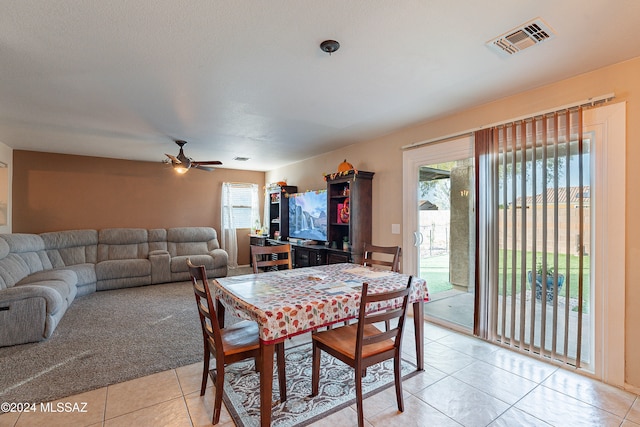 dining area featuring ceiling fan, a healthy amount of sunlight, and light tile patterned floors