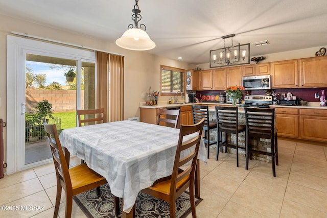 dining room with a chandelier and light tile patterned flooring