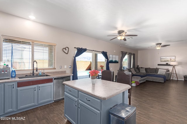 kitchen with sink, a center island, a healthy amount of sunlight, dark hardwood / wood-style flooring, and stainless steel dishwasher