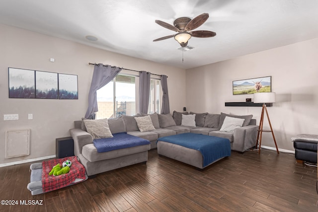 living room with ceiling fan and dark wood-type flooring